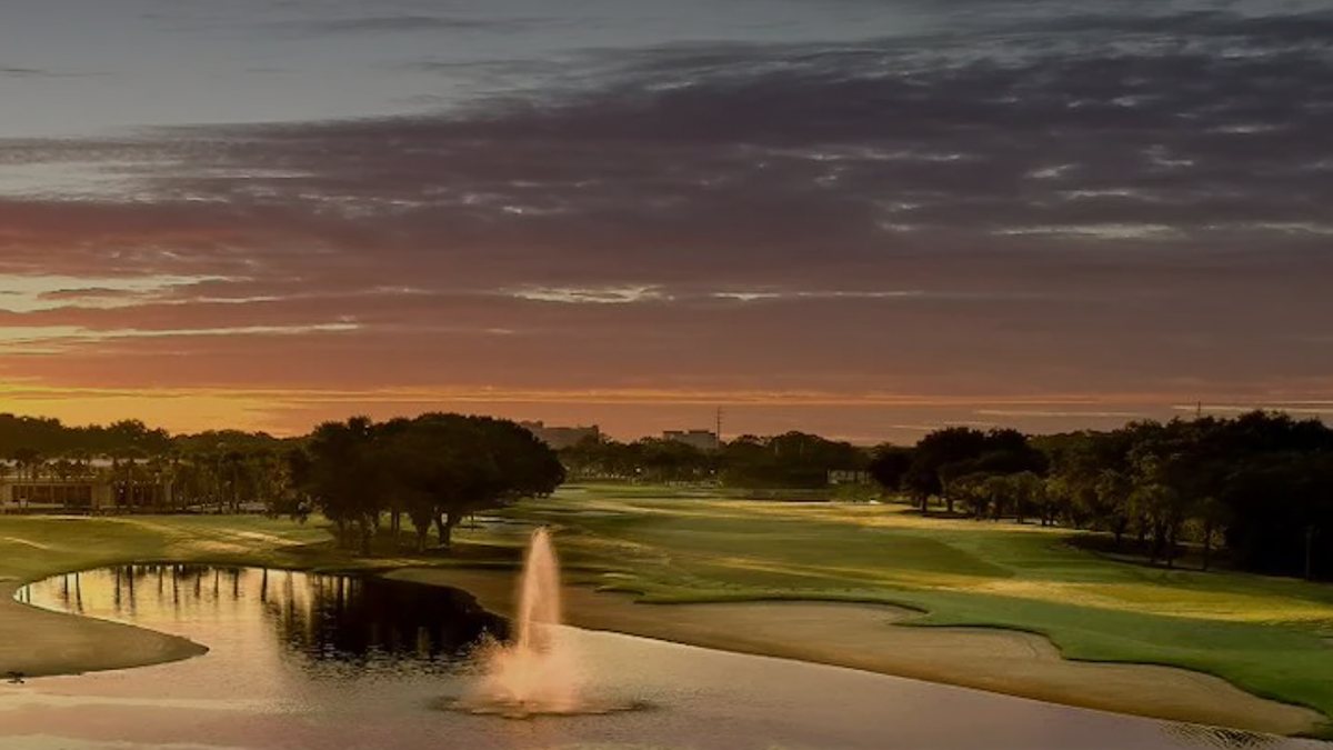 Sunset over a lake and fountain at Hawk's Landing Golf Club, Orlando World Center Marriott