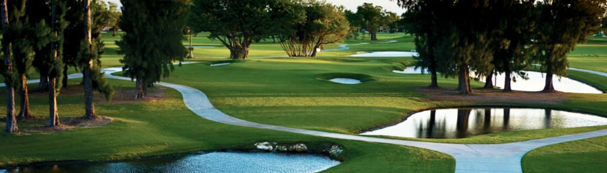 Cart path winding past ponds and trees at Normandy Shores Golf Club, one of the best golf courses in Florida for value