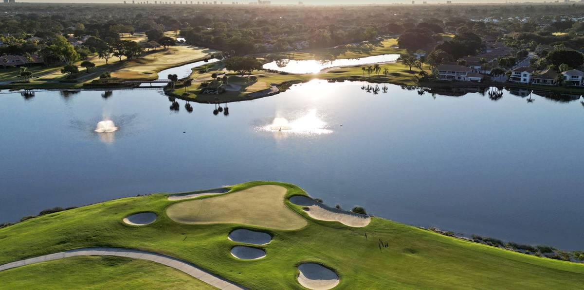 Aerial view of a lakeside green with bunkers at PGA National Resort in Palm Beach Gardens, home to some of the best golf courses in Florida